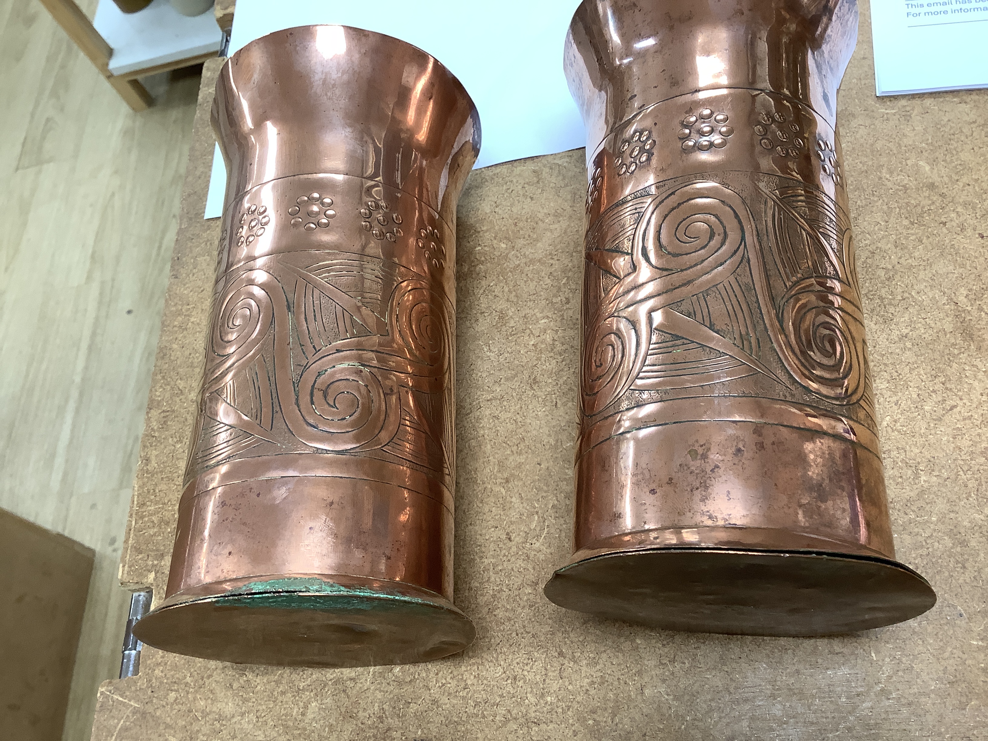 A pair of Keswick School of industrial art embossed copper cylinder vases, stamped KSIA to the bases, 20cm high